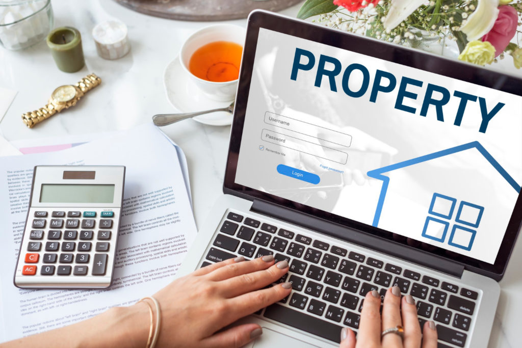 Conceptual image of property management on a laptop screen, used in a blog post discussing the Hindu Succession Act and property inheritance.